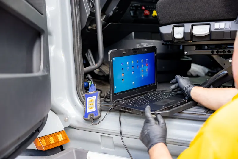 Technician inspecting a semi truck at Truck Shark