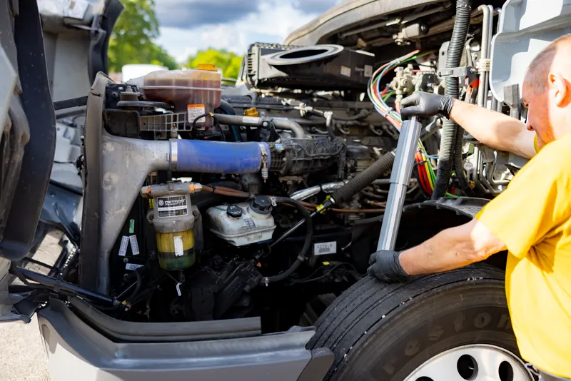 Mechanic working on an open diesel engine